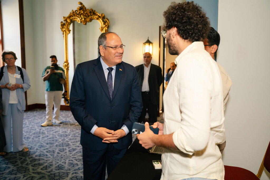 Seif Salama in conversation with a senior official